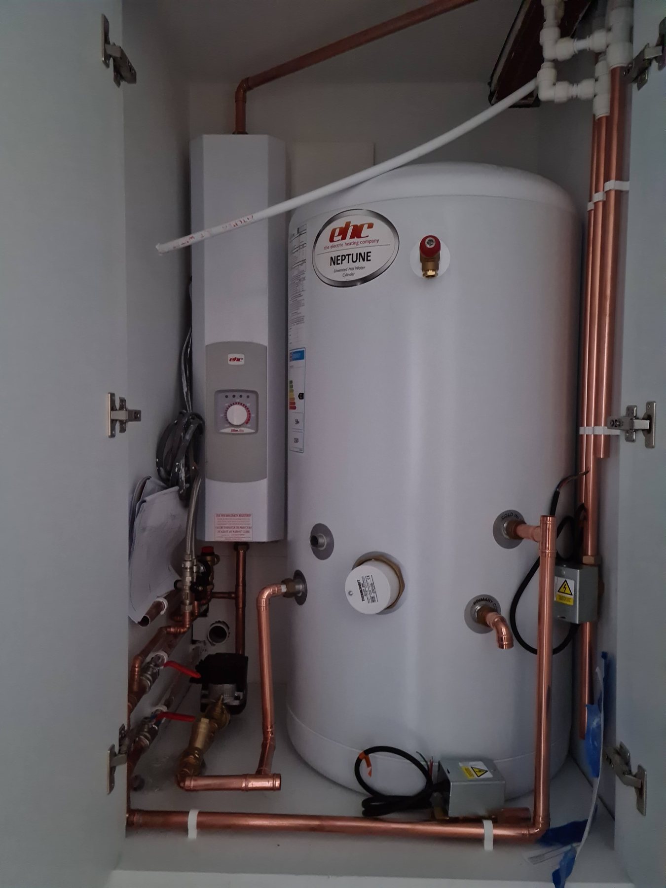 Unvented hot water cylinder installation with copper pipework and immersion controls