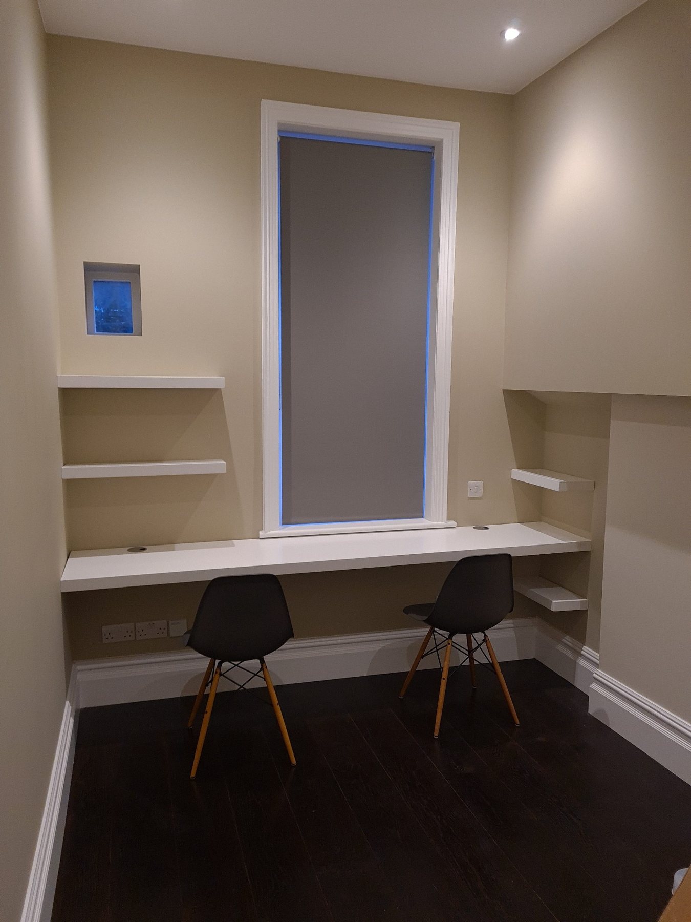 Bespoke fitted desk and shelving within a completed interior